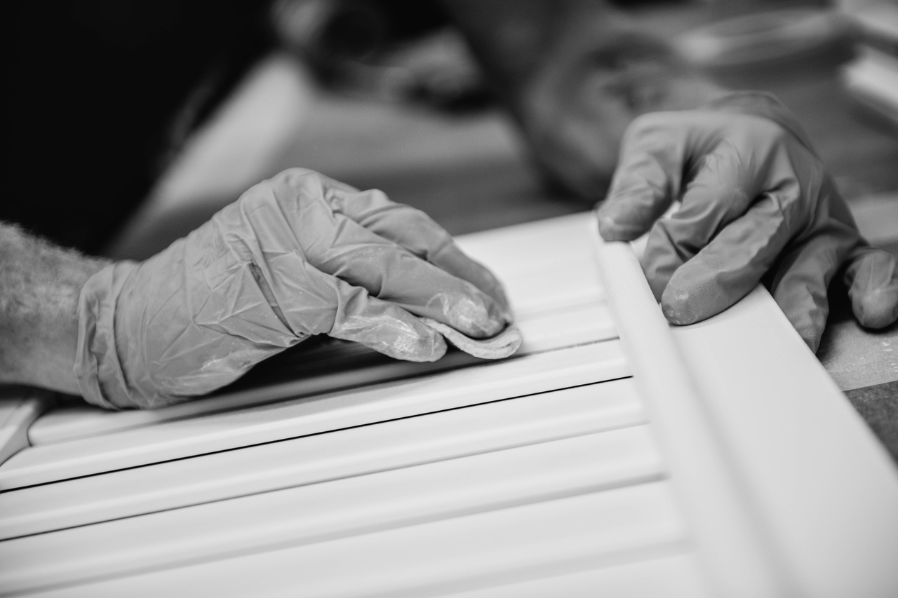 close up of employee applying the finishing touches on a shutter