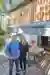 Matt and Lisa Tebbutt stood on their patio with their awning, a table and benches are positioned under the awning