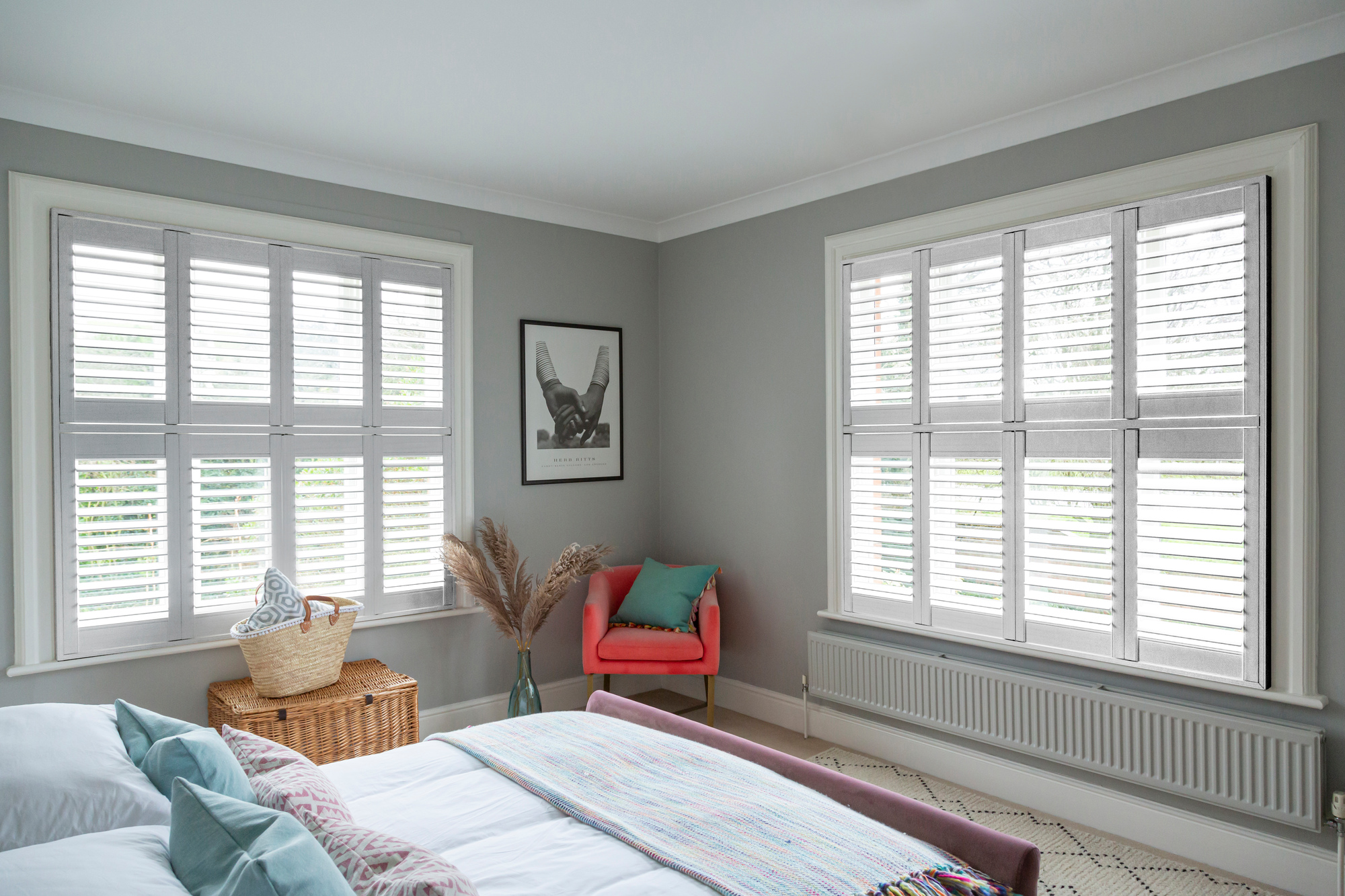 White birch shutters fitted to two windows in a grey decorated bedroom