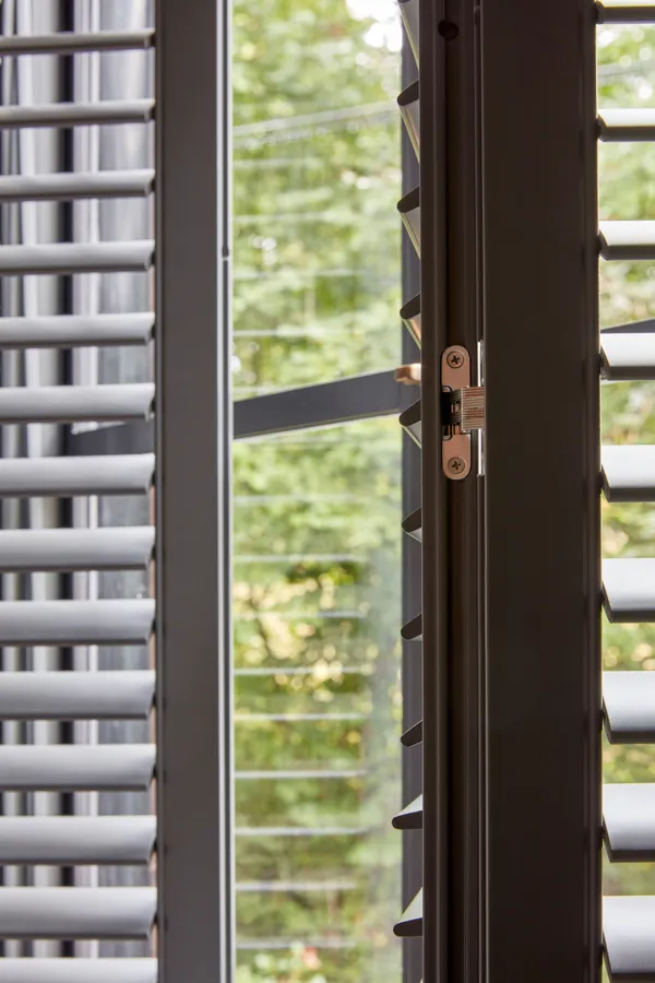 metal hinge on a opened grey shutter in the Tebbutts homne