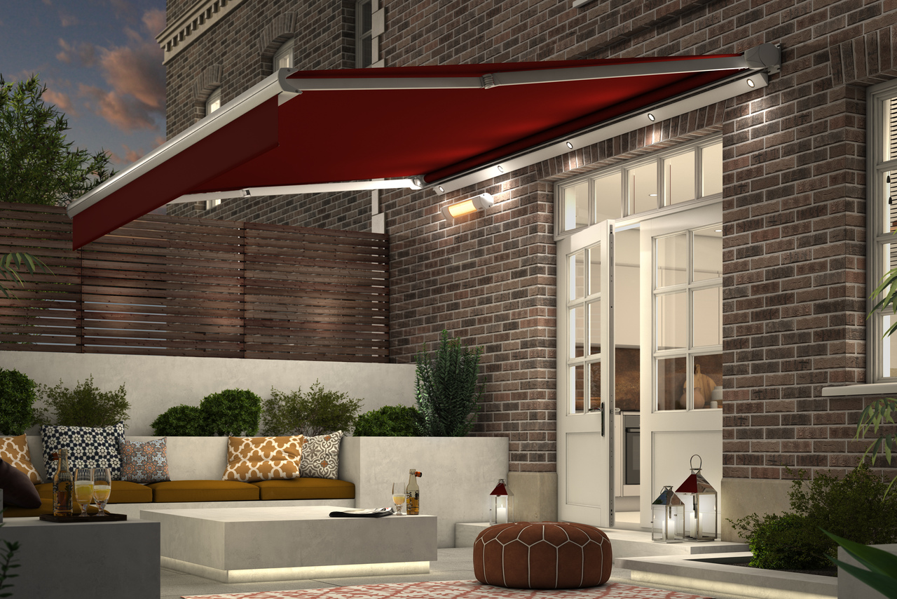 a red coloured awning hanging over a patio featuring plants and a bench decorated with cushions