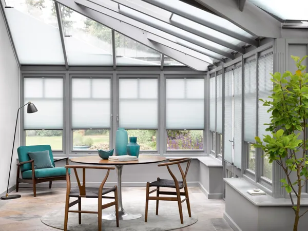 White Duette blinds fitted to multiple windows in a conservatory 