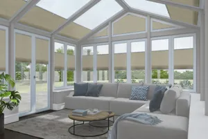 White conservatory with wooden floor, neutral l-shaped sofa, round coffee table on a cream rug with windows and doors dressed in creamy-beige duette blinds at varying heights with some roof blinds open.