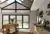 Kitchen with wooden island in front of a gable end window dressed in ochre blinds at varying levels.