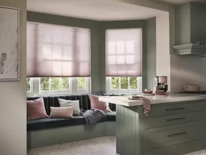 Pink Duette Blind fitted to a bay shaped window in a kitchen 