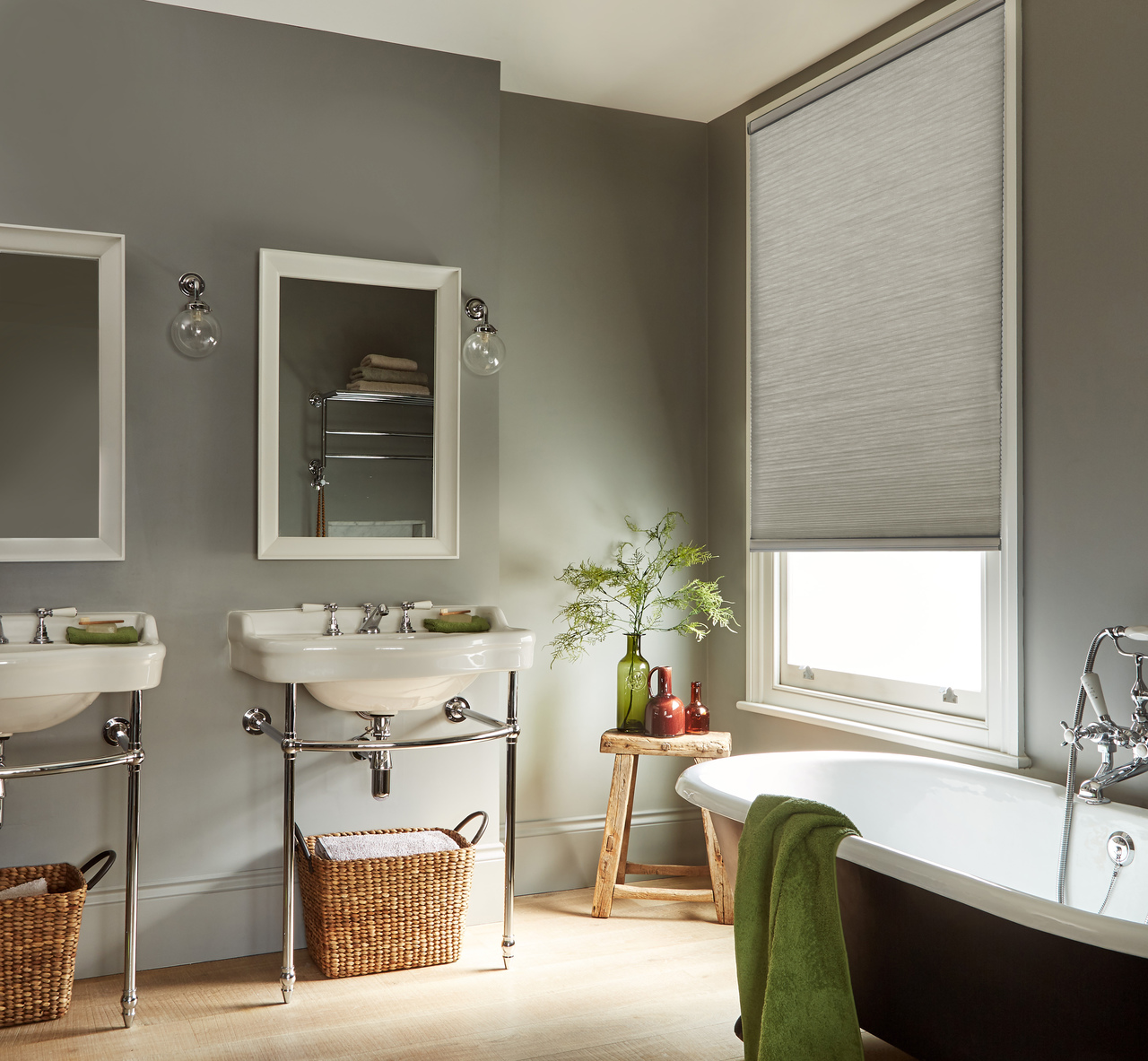 grey duette blinds fitted to a window in a bathroom